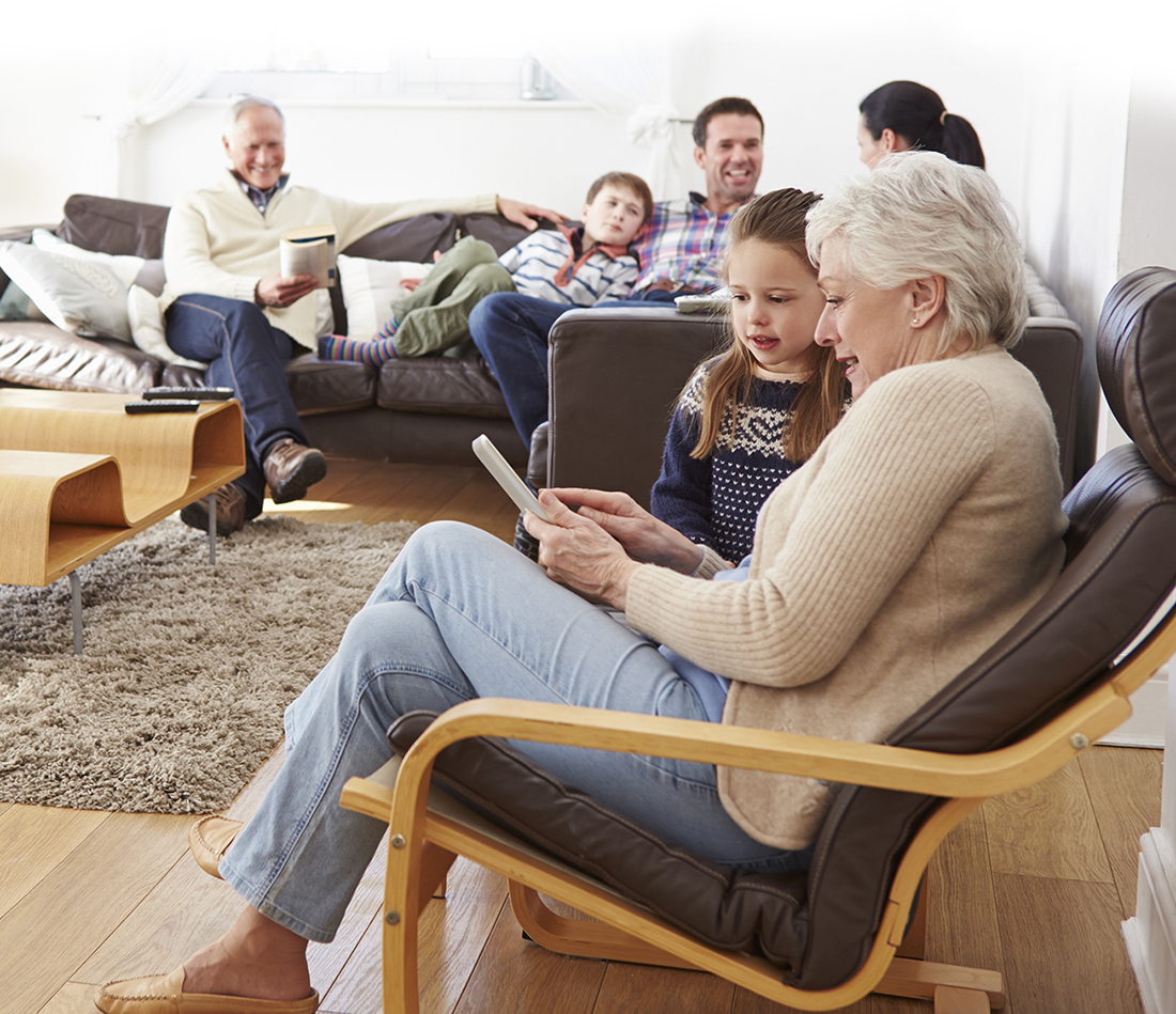 Multi Generation Family Relaxing At Home Together